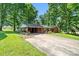 Brick ranch-style house with a long driveway and mature shade trees at 137 Deal Ln, Statesville, NC 28677