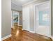 Hallway showcasing wood floors and a view into the blue bedroom and updated kitchen at 137 Deal Ln, Statesville, NC 28677