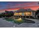 Beautifully landscaped backyard with a pool and firepit, perfect for outdoor entertaining and relaxation at dusk at 16430 New Providence Ln, Charlotte, NC 28277