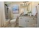 Well-lit bathroom with a bathtub, shower, and granite vanity, offering a clean and functional space at 16430 New Providence Ln, Charlotte, NC 28277