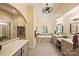Bright bathroom featuring dual vanities, a soaking tub, and modern fixtures at 16430 New Providence Ln, Charlotte, NC 28277
