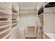 Walk-in closet featuring custom shelving, ample storage space, and an organized layout at 16430 New Providence Ln, Charlotte, NC 28277