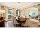 Elegant dining room with a chandelier, wallpaper, and views of the living room through an archway at 16430 New Providence Ln, Charlotte, NC 28277