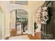 Elegant foyer featuring hardwood floors, arched doorways, and a staircase with wrought iron railings at 16430 New Providence Ln, Charlotte, NC 28277