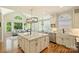 Open kitchen with island, stainless steel appliances, and modern lighting at 16430 New Providence Ln, Charlotte, NC 28277