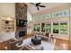 Bright living room featuring a stone fireplace and large windows at 16430 New Providence Ln, Charlotte, NC 28277