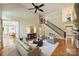 Large living room with staircase and abundant natural light at 16430 New Providence Ln, Charlotte, NC 28277