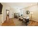 Bright living room featuring hardwood floors, stylish seating, chic decor, and a modern floor lamp at 16430 New Providence Ln, Charlotte, NC 28277