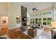 Spacious living room with a stone fireplace, built-in shelving, and ample natural light at 16430 New Providence Ln, Charlotte, NC 28277