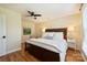 Comfortable main bedroom with a ceiling fan, hardwood floors, and a serene color palette at 16430 New Providence Ln, Charlotte, NC 28277