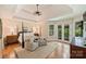 Serene main bedroom with a tray ceiling, hardwood floors, and a private balcony at 16430 New Providence Ln, Charlotte, NC 28277