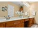 Bathroom featuring double sinks and a vanity, plus a decorative mirror and good lighting at 1666 Sam Smith Rd, Fort Mill, SC 29708