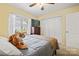 Inviting bedroom featuring a large closet, ceiling fan, and a window overlooking the backyard at 1666 Sam Smith Rd, Fort Mill, SC 29708