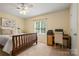 Bright bedroom with ceiling fan, window, work desk and furnishings at 1666 Sam Smith Rd, Fort Mill, SC 29708