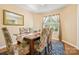 A well-lit dining room features a beautiful rug, wooden table, and comfortable, decorative chairs at 1666 Sam Smith Rd, Fort Mill, SC 29708