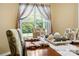 Charming dining area featuring a window, patterned chairs, and a meticulously decorated table setting at 1666 Sam Smith Rd, Fort Mill, SC 29708