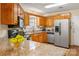 Bright kitchen featuring granite countertops, stainless steel appliances, and wood cabinets at 1666 Sam Smith Rd, Fort Mill, SC 29708