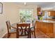 Inviting eat-in kitchen showcasing hardwood floors, warm wood cabinetry, and a sunny window view at 1666 Sam Smith Rd, Fort Mill, SC 29708