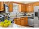 A kitchen with stainless steel appliances, granite countertops, light wooden cabinets, and a tiled backsplash at 1666 Sam Smith Rd, Fort Mill, SC 29708