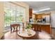 Bright kitchen featuring a round table, hardwood floors, and natural light streaming through the large window at 1666 Sam Smith Rd, Fort Mill, SC 29708