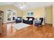 Open-concept living room with hardwood floors, vaulted ceiling, and access to the outdoor area at 1666 Sam Smith Rd, Fort Mill, SC 29708
