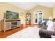 Living room with French doors, wood floors, and entertainment center, showcasing modern living at 1666 Sam Smith Rd, Fort Mill, SC 29708