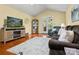 Cozy living room showcasing hardwood floors, a decorative fireplace, and plenty of natural light from French doors at 1666 Sam Smith Rd, Fort Mill, SC 29708