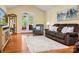 Inviting living room with hardwood floors, a neutral rug, and a comfortable brown sofa near the French doors at 1666 Sam Smith Rd, Fort Mill, SC 29708