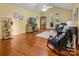 Bright living room featuring hardwood floors, ceiling fan, and a comfortable rocking chair, offering a warm ambiance at 1666 Sam Smith Rd, Fort Mill, SC 29708