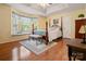 Main bedroom showcasing hardwood floors, a ceiling fan, a bay window, and a four-poster bed at 1666 Sam Smith Rd, Fort Mill, SC 29708