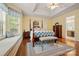 Main bedroom with a bay window and bench, hardwood floors, a ceiling fan, and a four-poster bed at 1666 Sam Smith Rd, Fort Mill, SC 29708