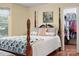 Bright bedroom showing walk-in closet, complemented by hardwood floors and soft yellow walls at 1666 Sam Smith Rd, Fort Mill, SC 29708