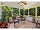 Relaxing screened porch with tiled floor, ceiling fan, and comfortable seating at 1666 Sam Smith Rd, Fort Mill, SC 29708