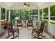Cozy screened porch furnished with rocking chairs and a ceiling fan, perfect for outdoor relaxation at 1666 Sam Smith Rd, Fort Mill, SC 29708