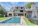 Beautiful backyard pool area with a hot tub, trampoline, and a view of the home's exterior at 1919 Shoreham Dr, Charlotte, NC 28211