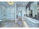 Modern bathroom showcasing a glass shower, soaking tub, and double sink vanity at 1919 Shoreham Dr, Charlotte, NC 28211