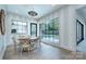 Bright dining area with a view of the landscaped backyard and pool, black-framed windows and a pendant light at 1919 Shoreham Dr, Charlotte, NC 28211