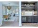 Elegant dining room featuring a bar, stylish chandelier, and hardwood flooring at 1919 Shoreham Dr, Charlotte, NC 28211