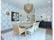 Well-lit dining room with statement chandelier, modern artwork, and seating for eight at 1919 Shoreham Dr, Charlotte, NC 28211