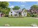 Charming two-story home with landscaped yard and a large manicured front lawn at 1919 Shoreham Dr, Charlotte, NC 28211