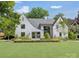 Stunning exterior view of a two-story home with manicured lawn and lush landscaping at 1919 Shoreham Dr, Charlotte, NC 28211