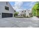 Wide view of home's exterior, garage and pool area at 1919 Shoreham Dr, Charlotte, NC 28211