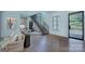 Bright foyer features a staircase with iron railings and hardwood floors, complemented by natural light at 1919 Shoreham Dr, Charlotte, NC 28211