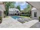 Beautiful pool area with tanning deck and view of the home's exterior at 1919 Shoreham Dr, Charlotte, NC 28211