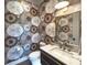 Stylish powder room features designer wallpaper, a modern vanity, and elegant lighting at 1919 Shoreham Dr, Charlotte, NC 28211