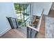Modern staircase featuring hardwood steps and a large window with backyard views at 1919 Shoreham Dr, Charlotte, NC 28211