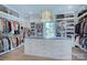 Spacious walk-in closet with custom shelving, drawers, and a center island at 1919 Shoreham Dr, Charlotte, NC 28211