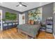 Cozy bedroom with hardwood floors, accent wall, and a comfortable queen-size bed at 2006 Upstate Way, Charlotte, NC 28206
