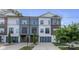 Modern townhome showcasing a contemporary design with a private garage and well-maintained landscaping at 2006 Upstate Way, Charlotte, NC 28206