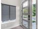 Modern front door with glass inserts and gray trim, complemented by a roller shade covered window at 2006 Upstate Way, Charlotte, NC 28206